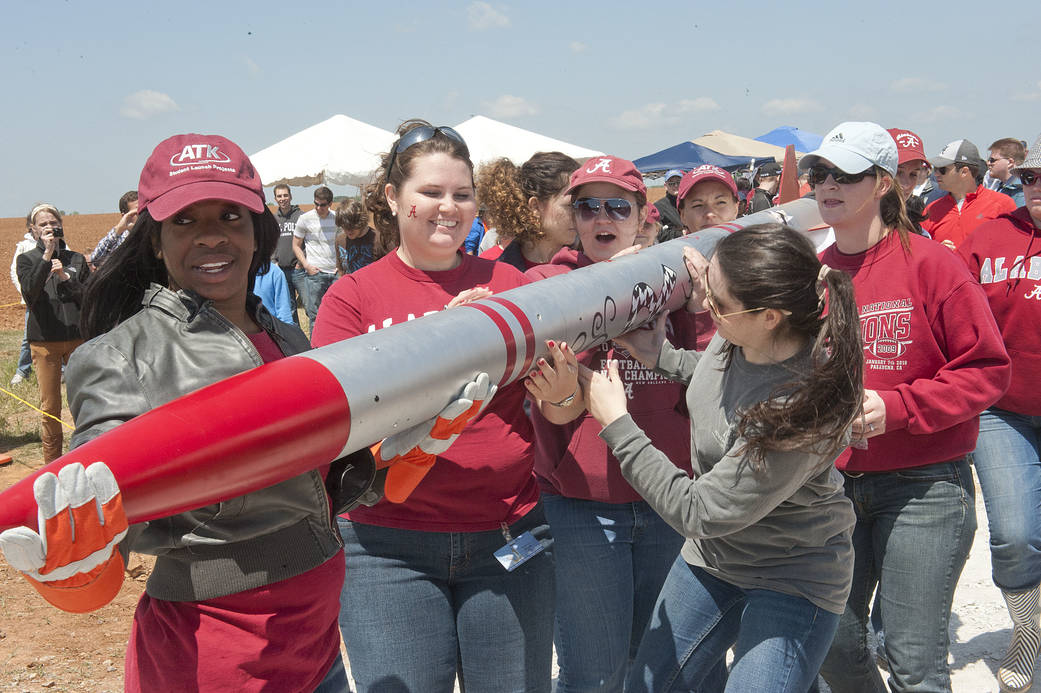 Girls carrying a rocket