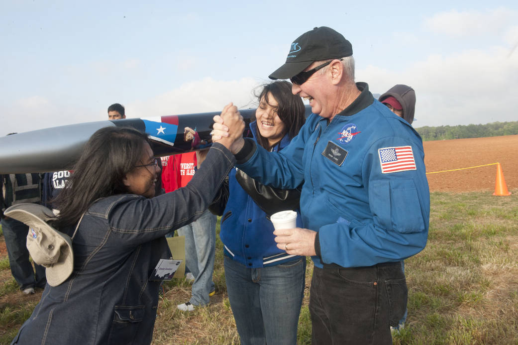 A woman high fives astronaut