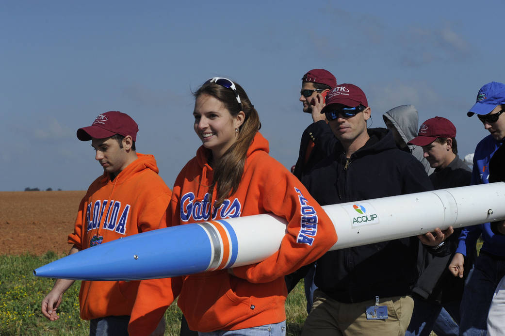 Students carrying rocket