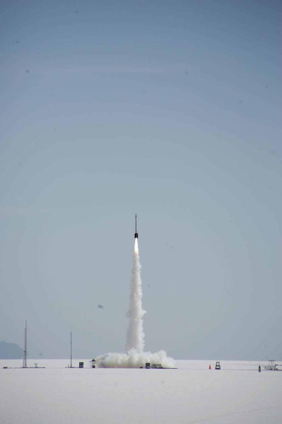 A rocket launches from a desert landscape