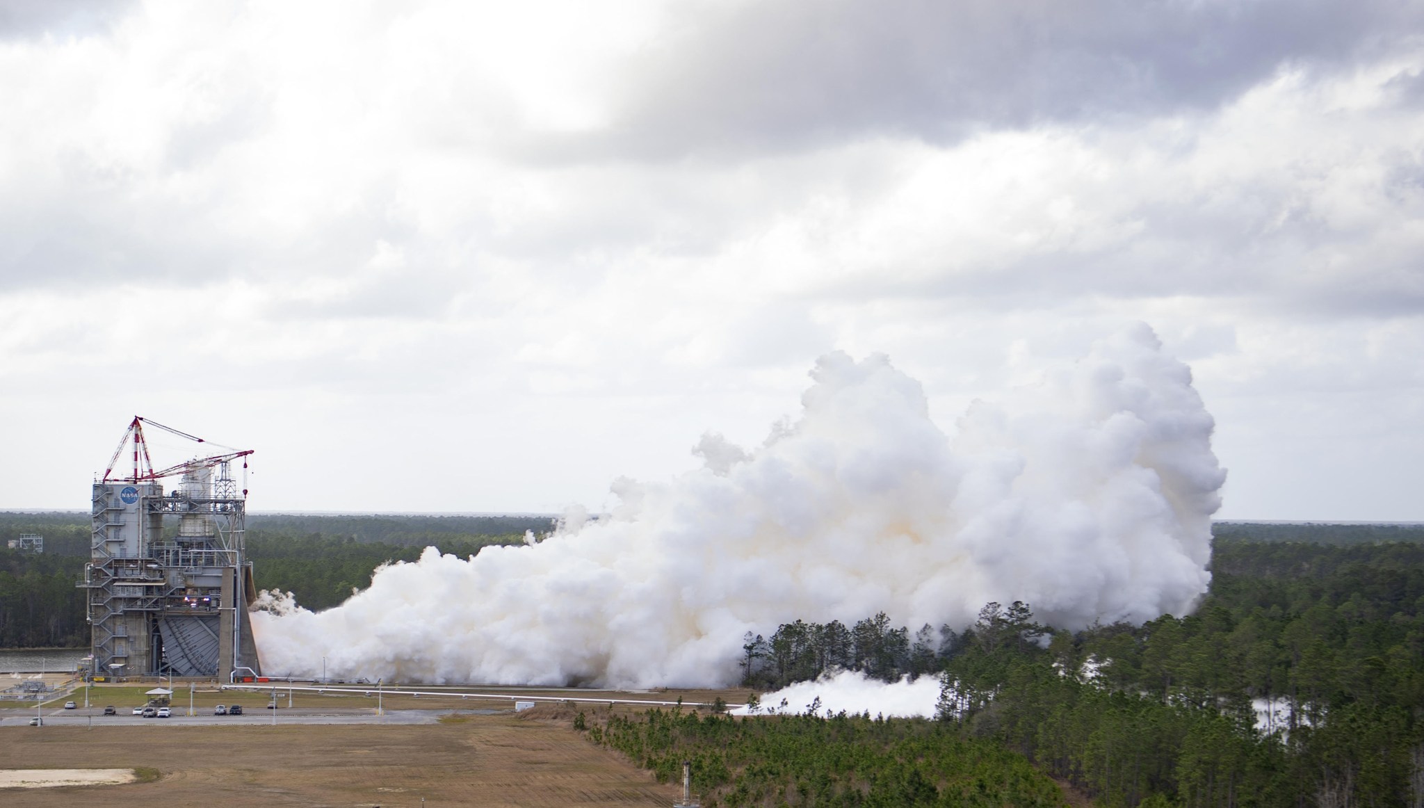 Smoke billows from a hot fire engine test for the Space Launch System rocket.