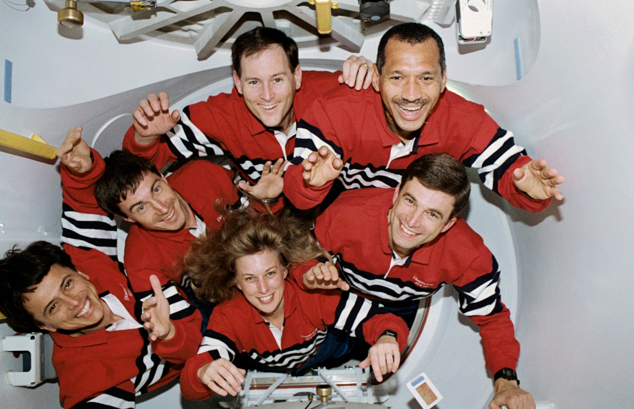 Five NASA astronauts and a Russian cosmonaut squeeze through the tunnel which connects the shirt-sleeve environment of the Space Shuttle Discovery and the SPACEHAB module. SPACEHAB is located in the spacecraft's payload bay. Charles F. Bolden Jr., mission commander, is at upper right. Others, clockwise from the commander, are Ronald M. Sega and N. Jan Davis, mission specialists; Franklin R. Chang-Diaz, payload commander; Cosmonaut Sergei K. Krikalev, mission specialist; and Kenneth S. Reightler Jr., pilot.