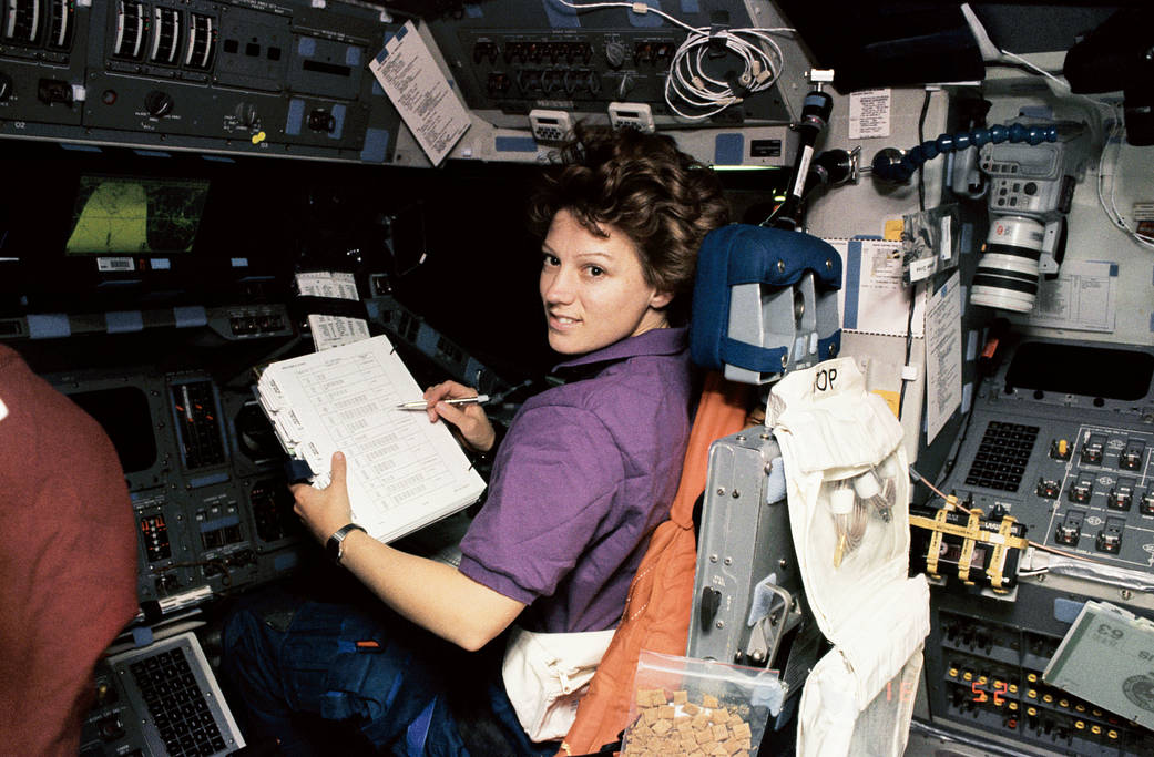 Astronaut Eileen Collins at pilot's station onboard shuttle Discovery