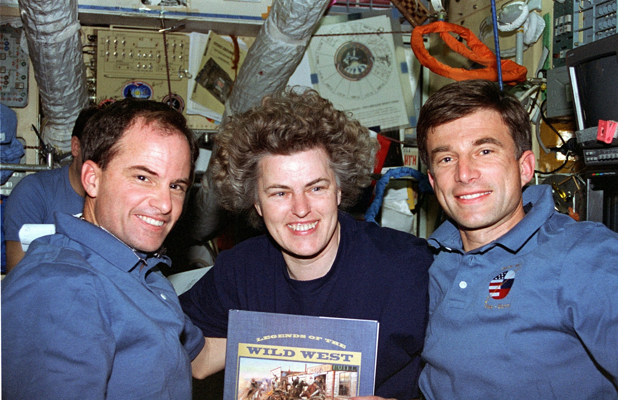 STS-76 Commander Kevin Chilton and Mission Specialist Ron Sega present a book, "Legends of the Wild West", to the new Mir 21 crewmember Shannon Lucid.
