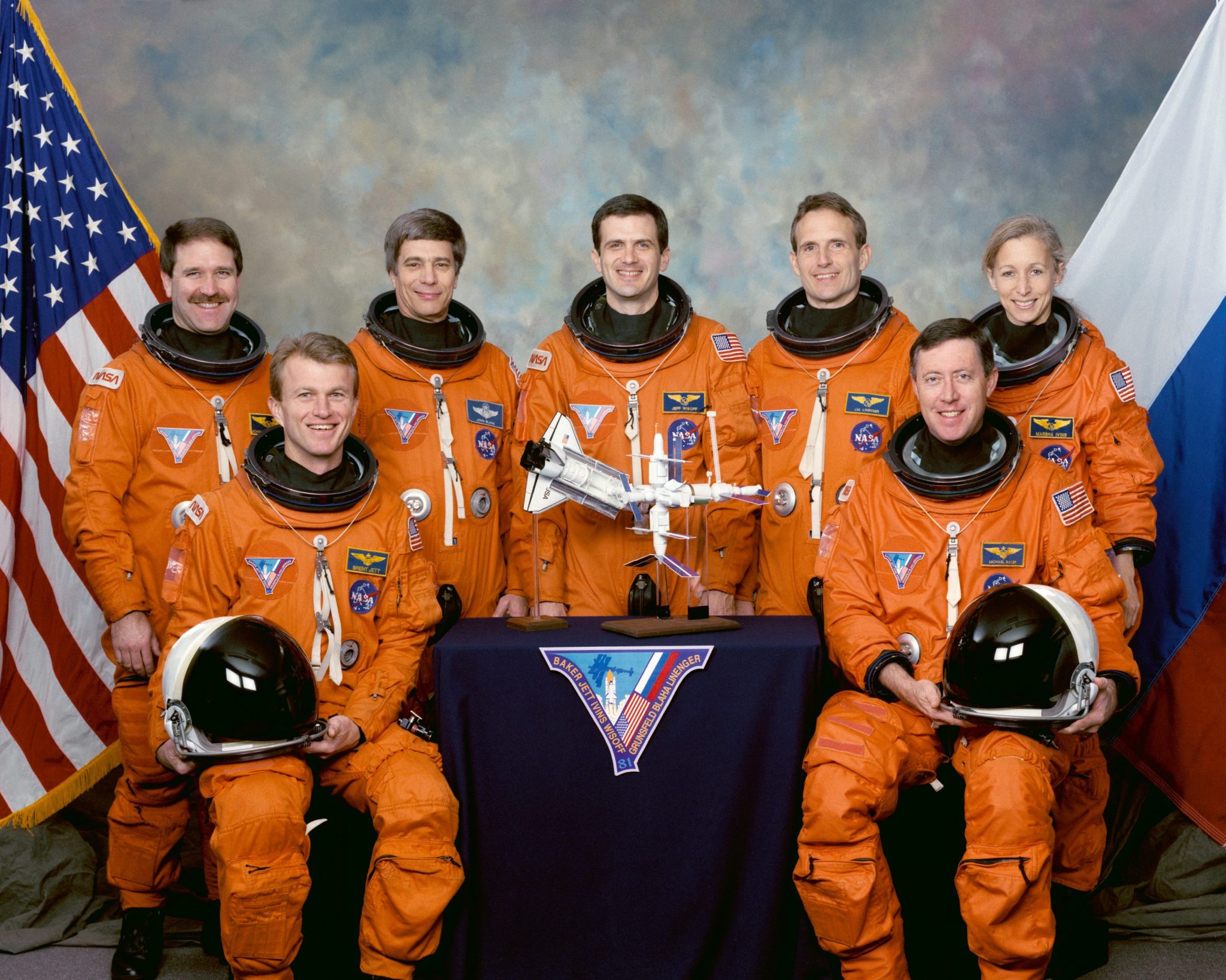 STS-81 official crew portrait in orange launch and entry suits.