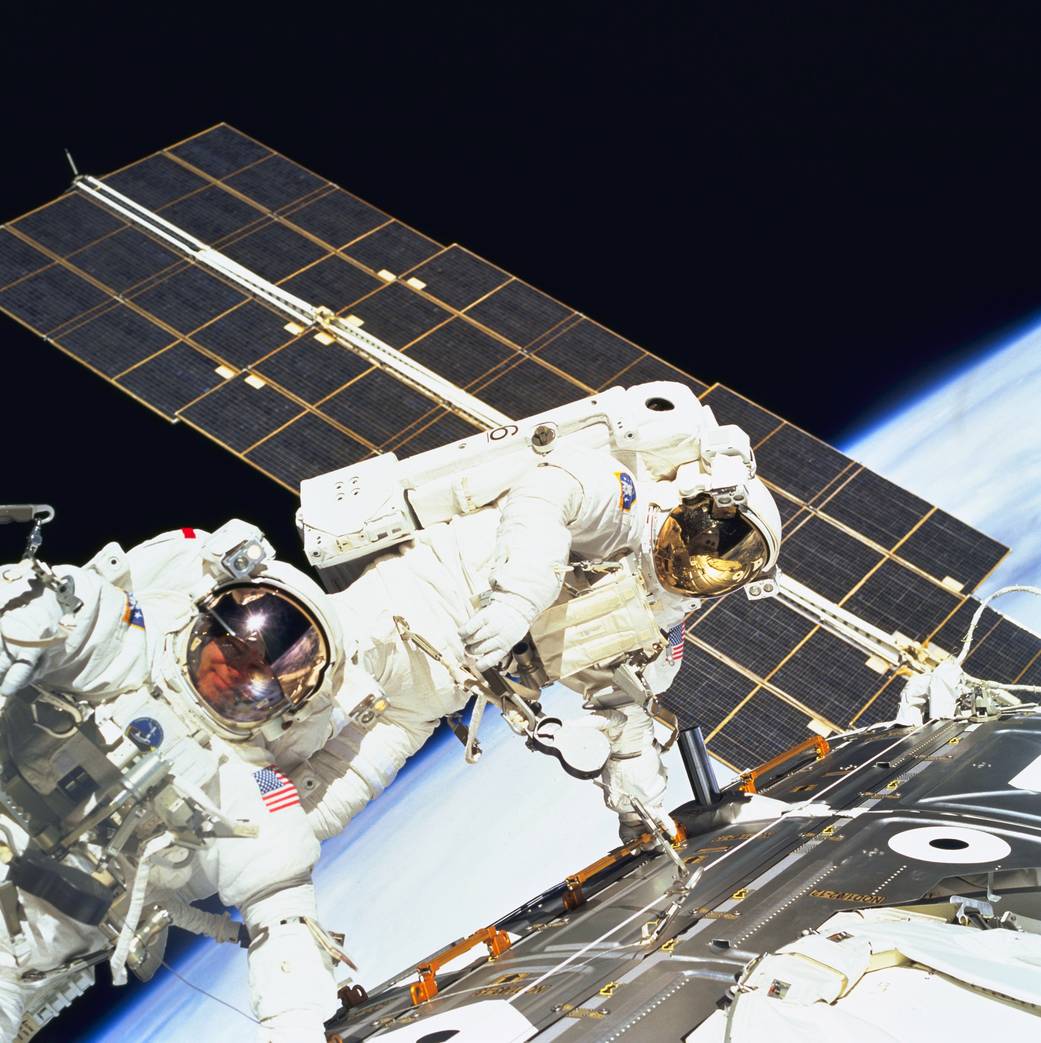 Two astronauts spacewalking outside the Zarya module of the space station