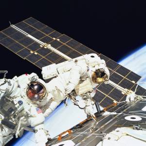 Two astronauts spacewalking outside the Zarya module of the space station