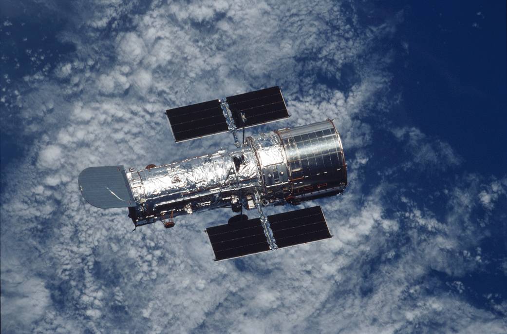 Hubble space telescope in orbit with Earth below
