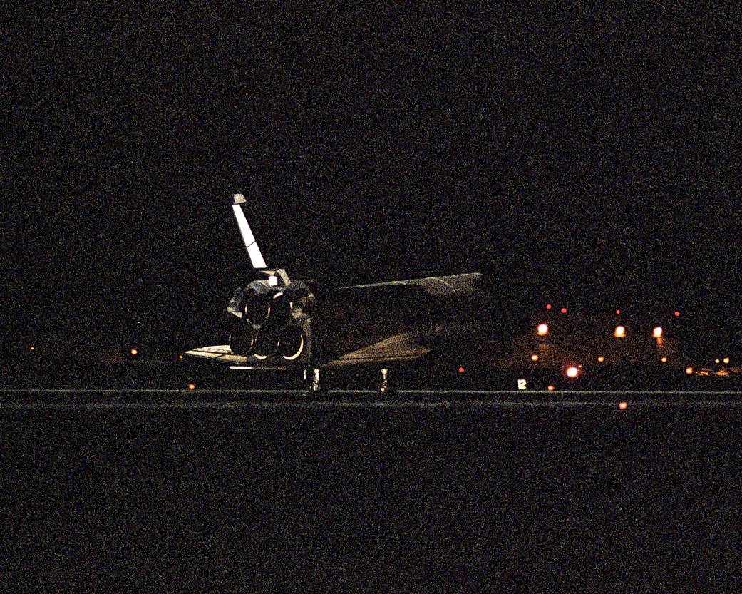 Shuttle lands on runway at night