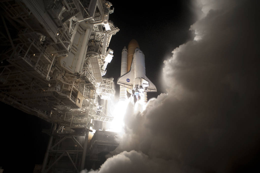 Liftoff of shuttle Discovery from Cape Canaveral at night