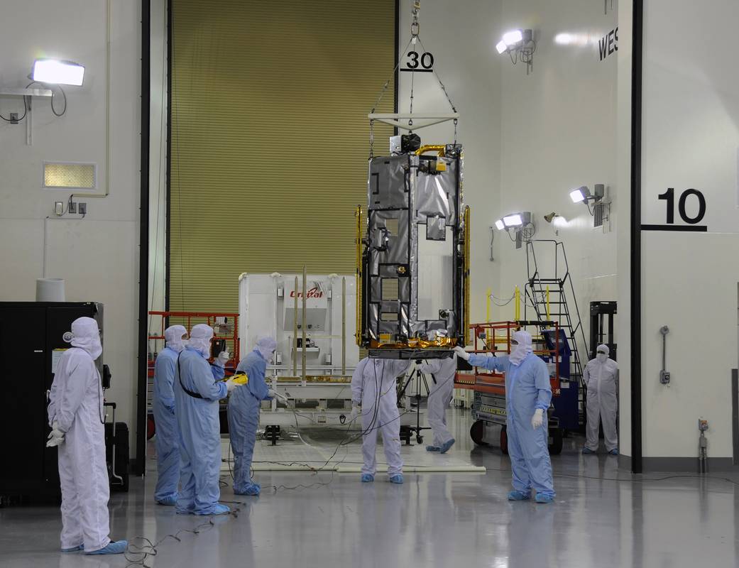 NASA's Orbiting Carbon Observatory-2, or OCO-2, is shown gliding across the Astrotech payload processing facility on Vandenberg 