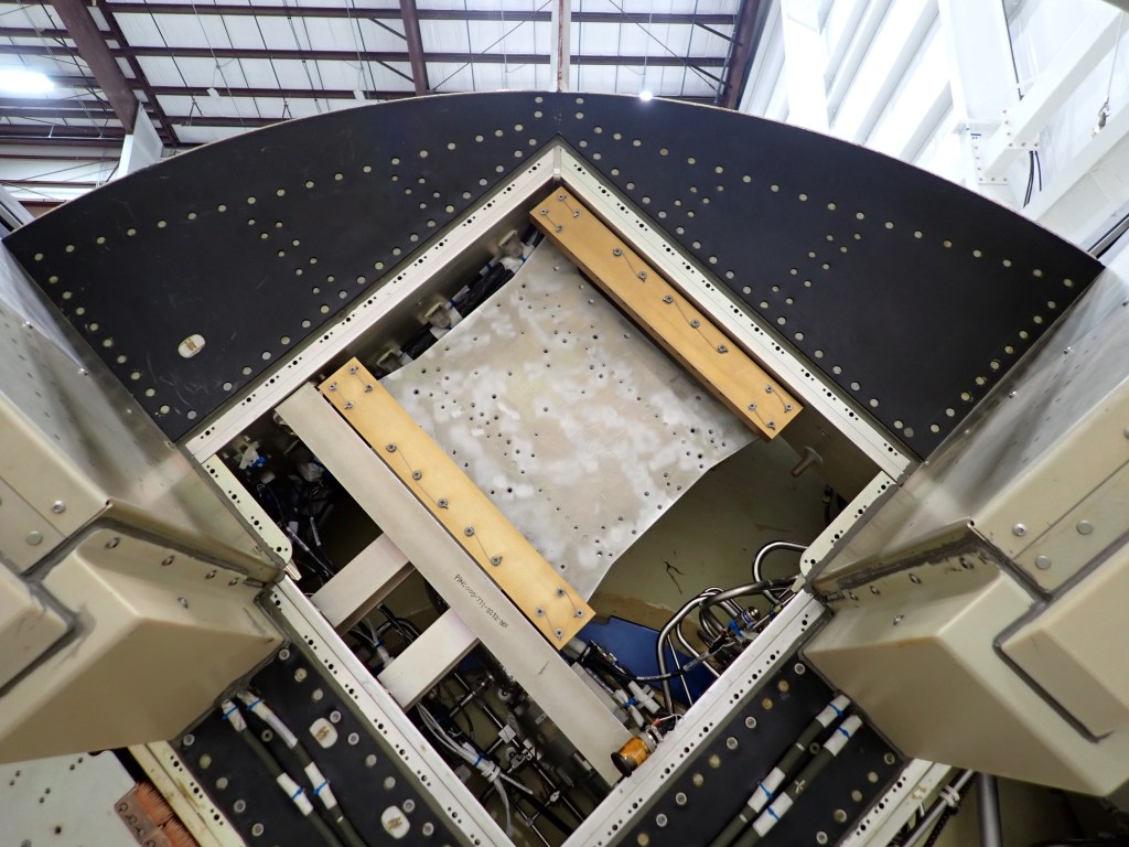 The black circular top of the rocket has a square opening and shows the mounted base that holds the JANUS technology.