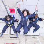 Three people jump in the air on a flight to promote disability inclusion.