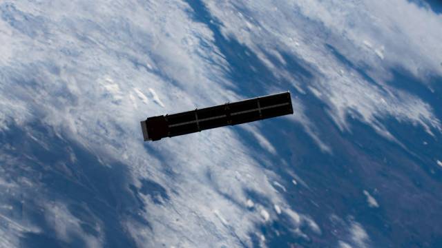 A small and thin satellite in orbit around Earth.