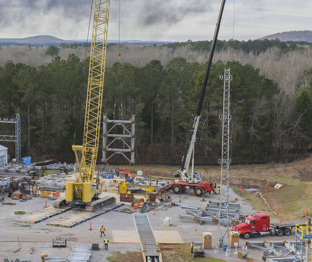 A crane moves the first steel tier to be bolted into place on Jan. 6.