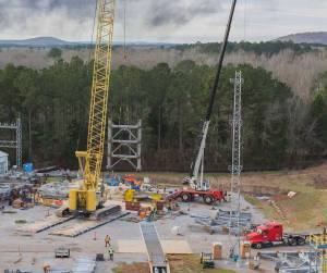 A crane moves the first steel tier to be bolted into place on Jan. 6.