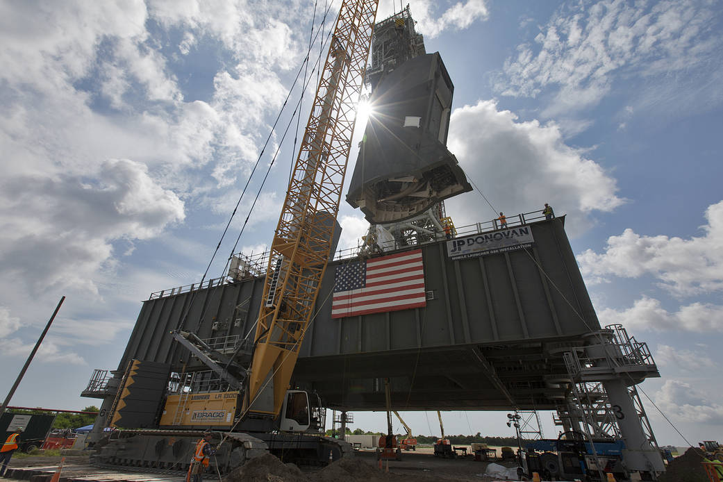 The second of two Tail Service Mast Umbilicals is lifted for installation on the 0-level deck of the mobile launcher.