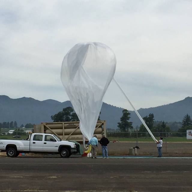 Technicians fill and prepare a Near Space Corporation high-altitude balloon.