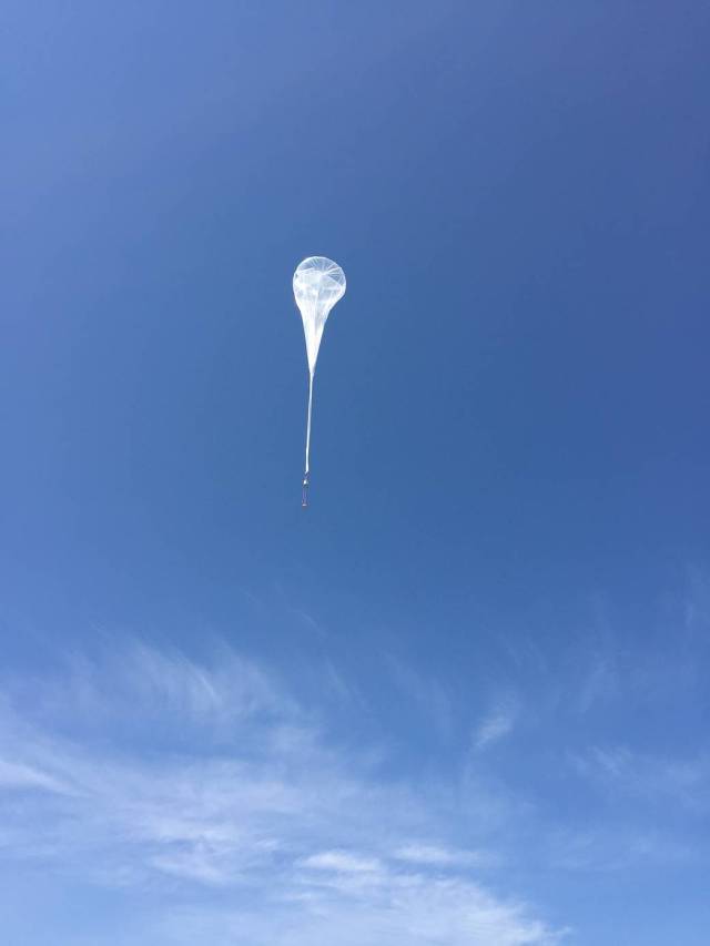 A Near Space Corporation high-altitude balloon lifts a prototype space reentry capsule for its initial flight test.