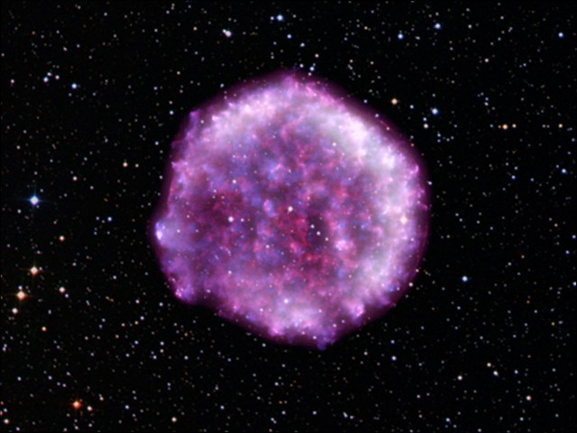 A purple pink circle in the middle of the vastness of space and stars represents an exploded star.