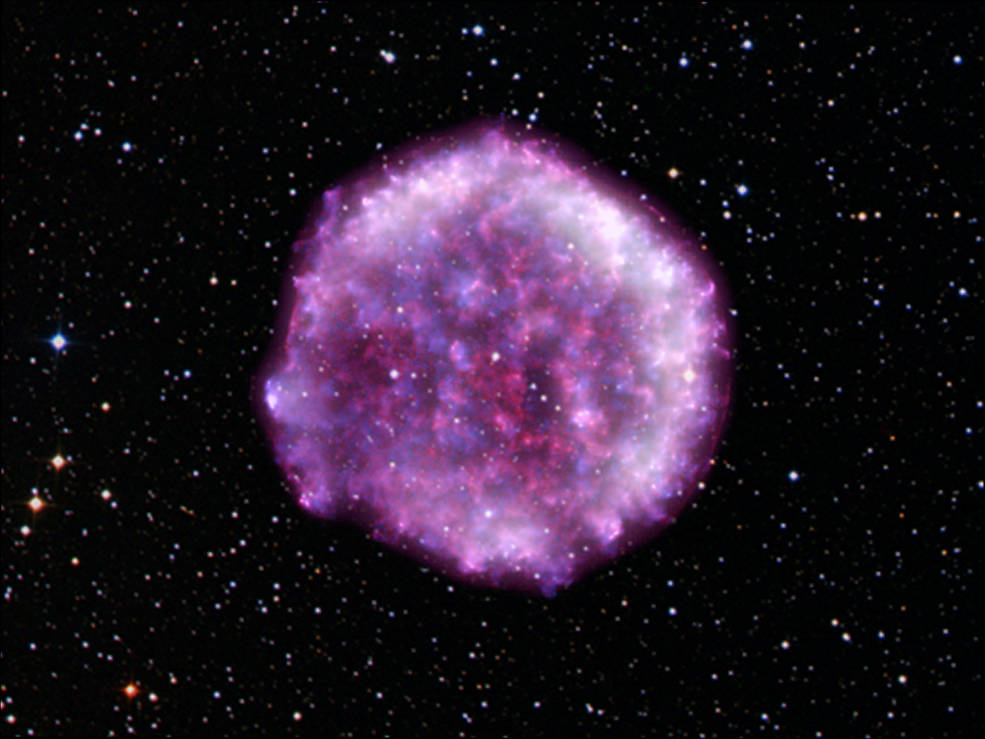 A purple-pink circular blob that is in the center of the photo that represents the Tycho supernova remnant.