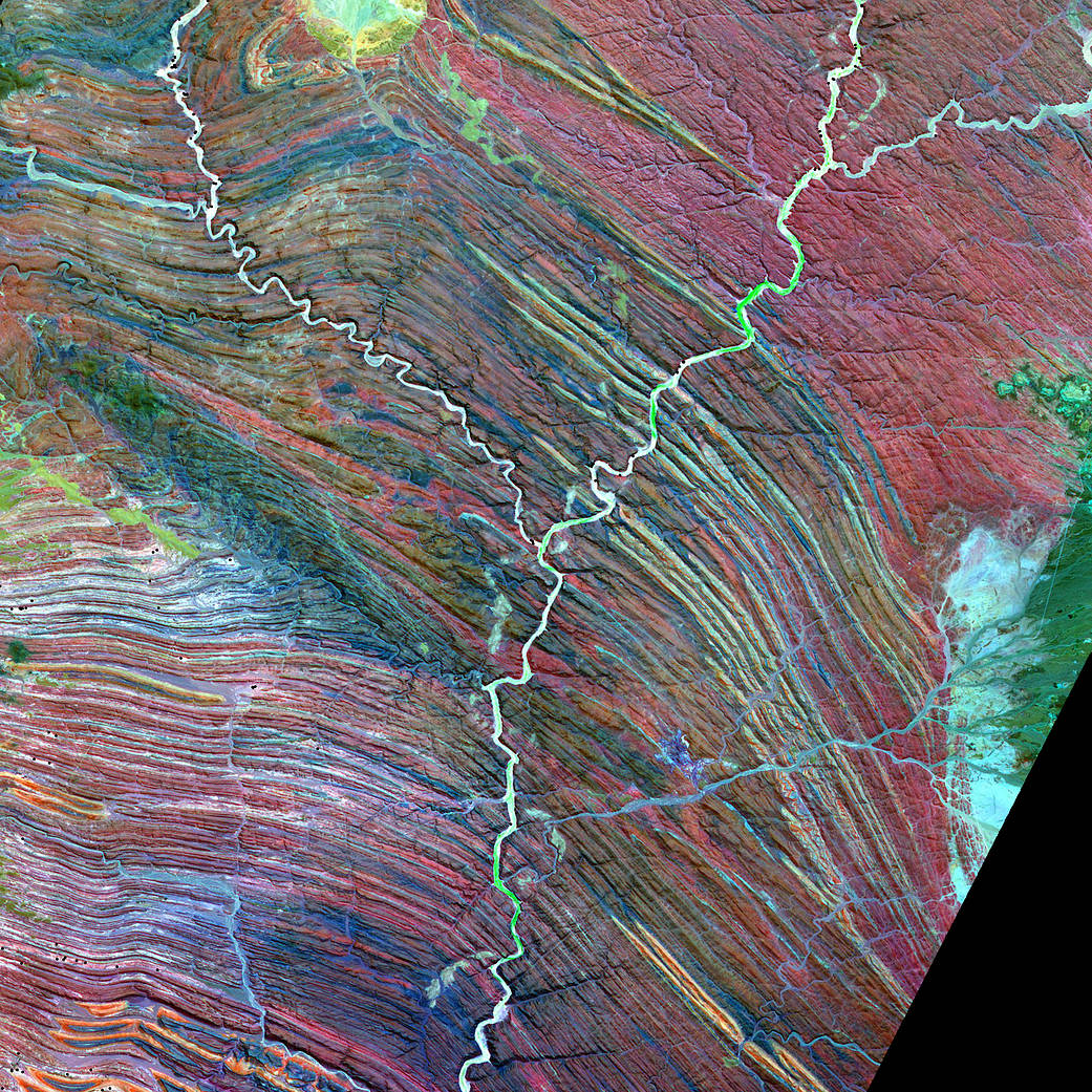 River in shape of letter 'y' flowing through field of elongated landforms or yardangs