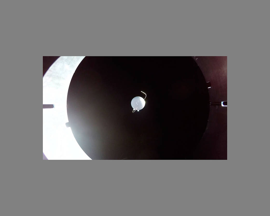 An UP Aerospace camera mounted on the launch vehicle shows the Mariai capsule after ejection and  returning to Earth.