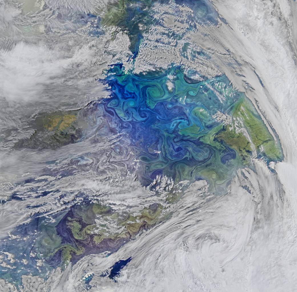 Satellite view of South Atlantic showing swirls of phytoplankton and clouds