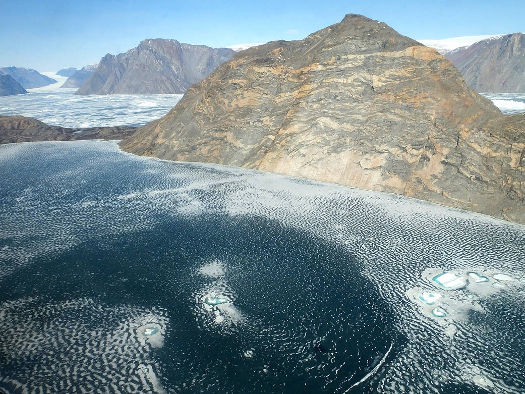 Overhead view of glacier with mountain in distance