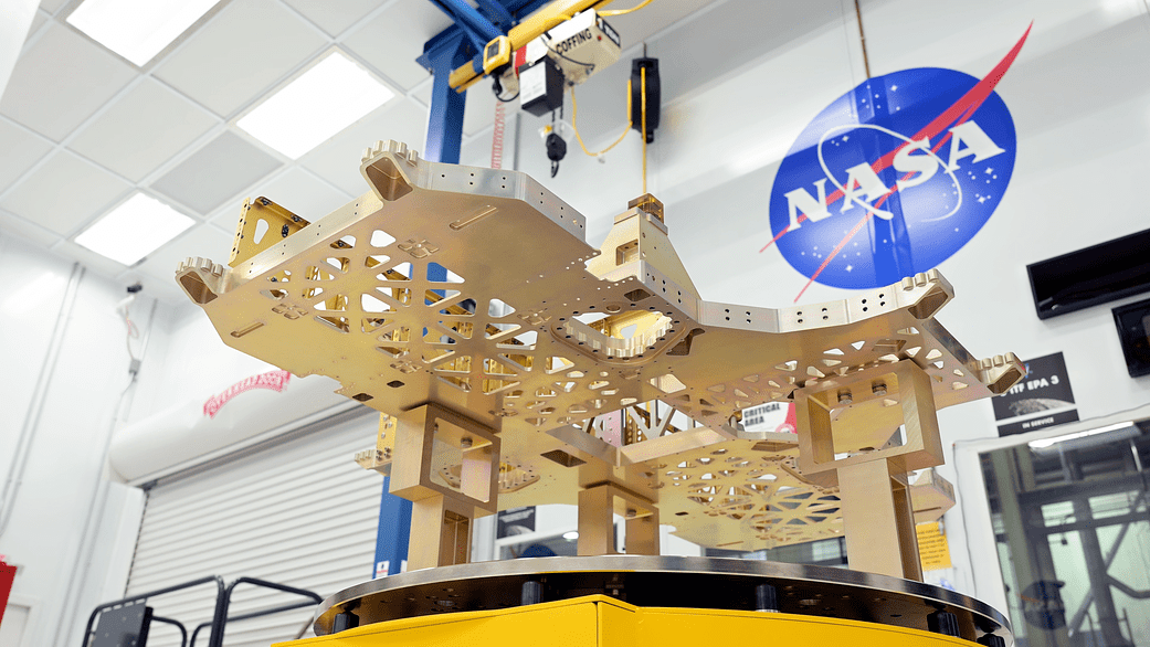 The VIPER chassis sits in the clean room with the NASA logo in the background.