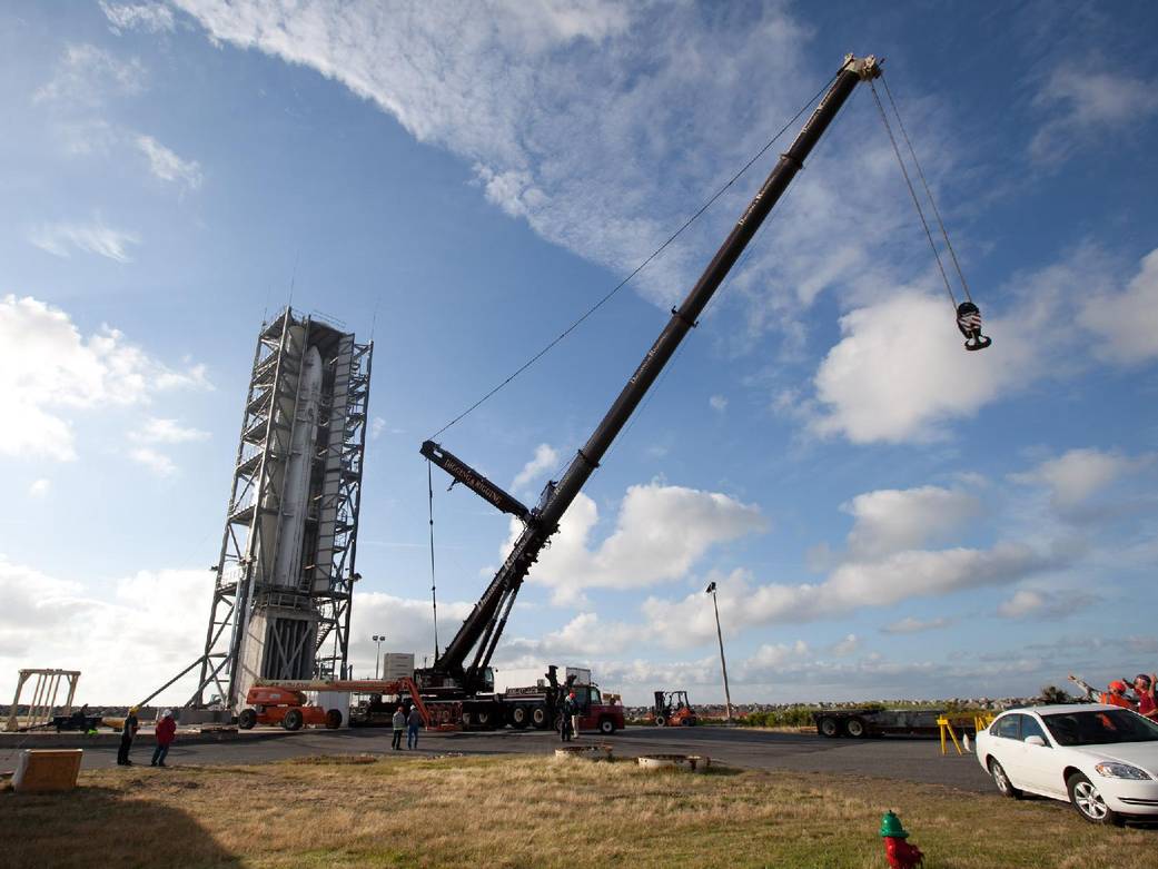 Rocket at NASA Wallops launchpad with crane nearby