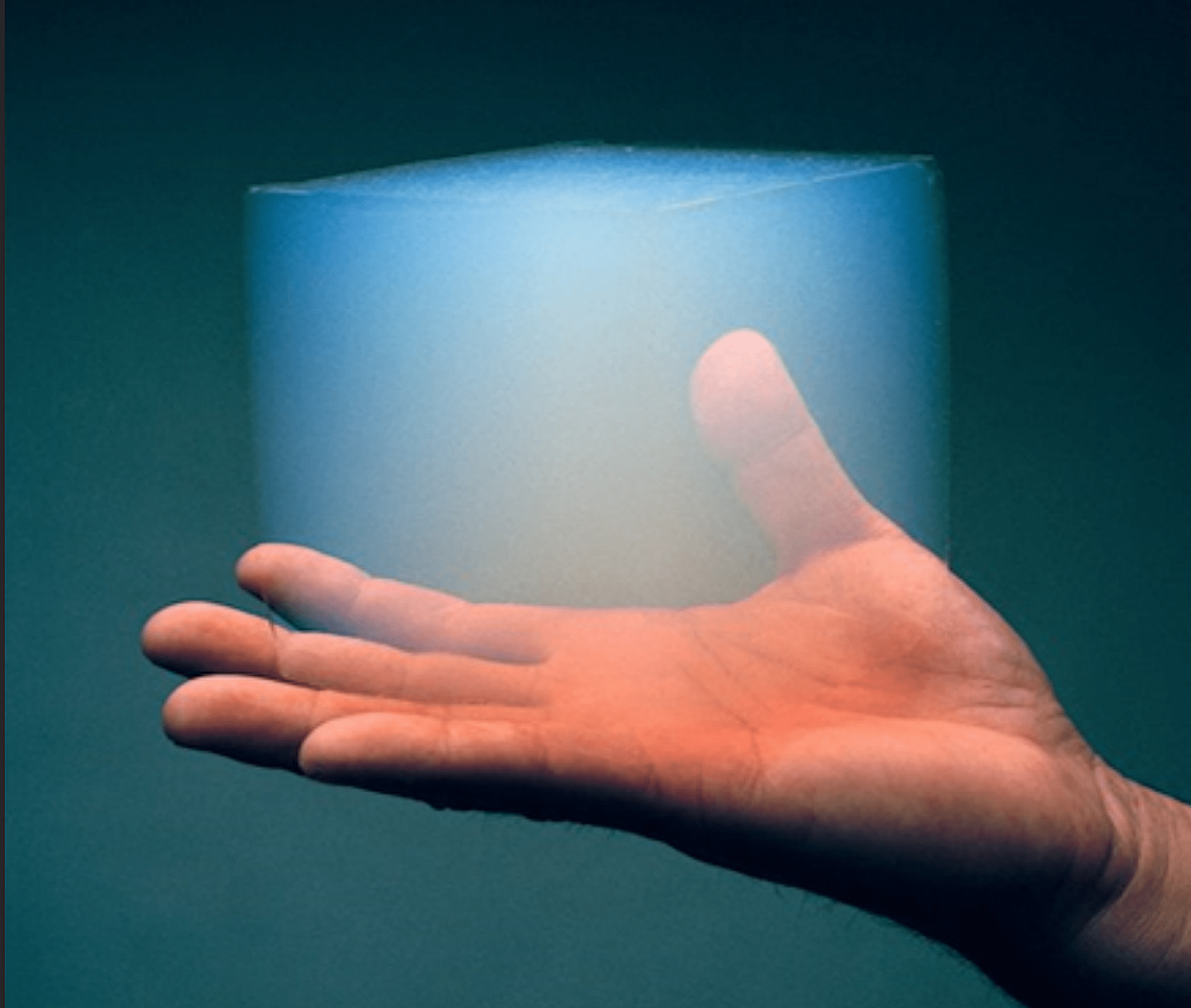 Blue light shining onto a human hand.