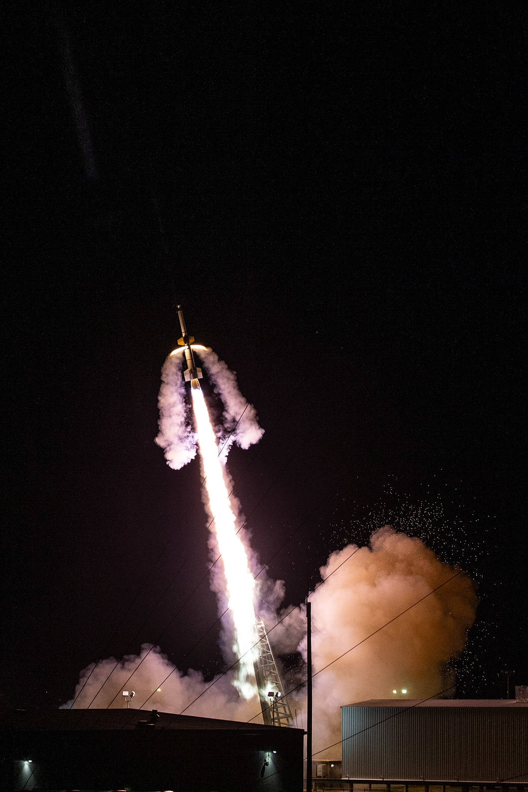 Night time sounding rocket launch with exhaust plumes from the rocket and 