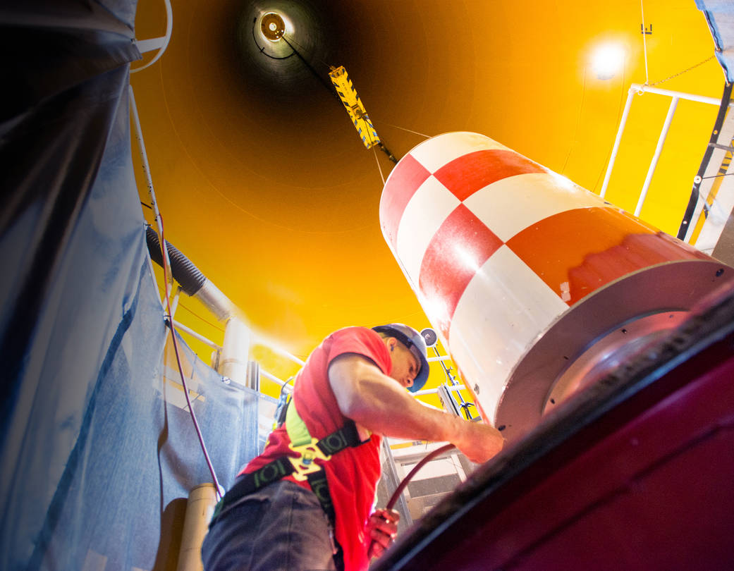 Technician Alex Camargo retrieves a drop vehicle after its 432-foot free fall in Glenn’s Zero Gravity facility