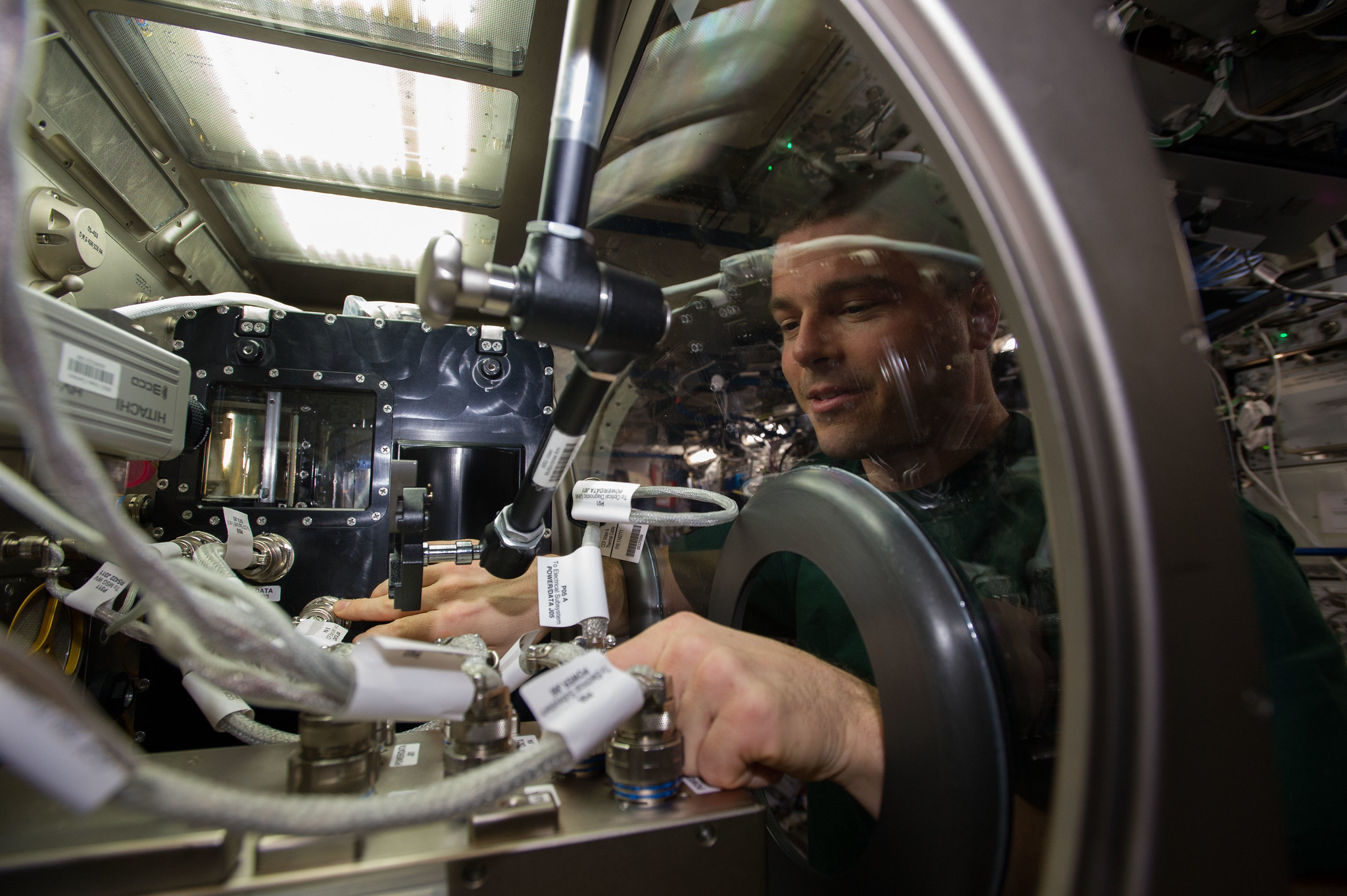 Astronaut performing a science experiment on the International Space Station