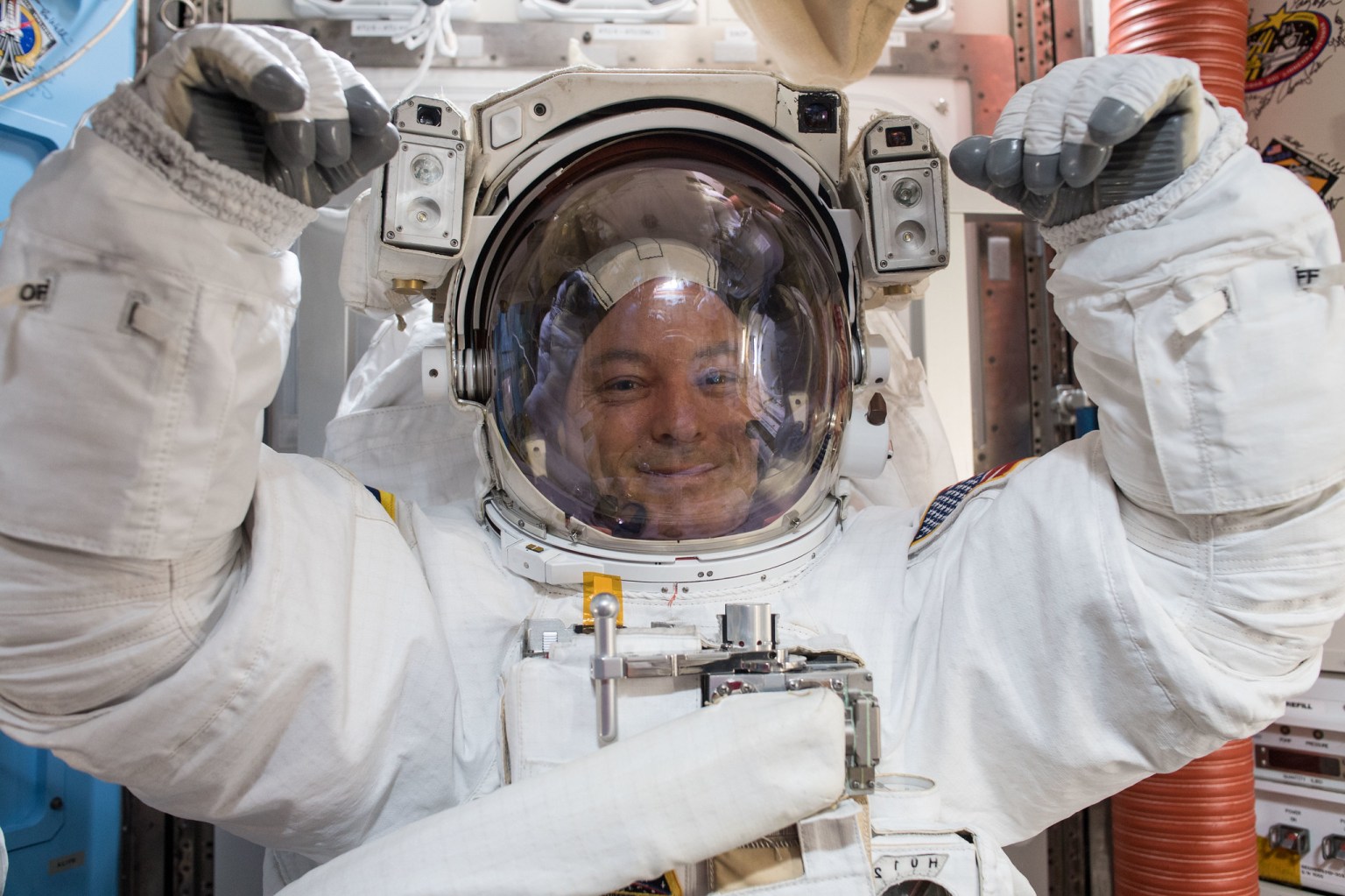 NASA astronaut Scott Tingle wears a U.S. spacesuit inside the Quest Airlock preparing for his first spacewalk.