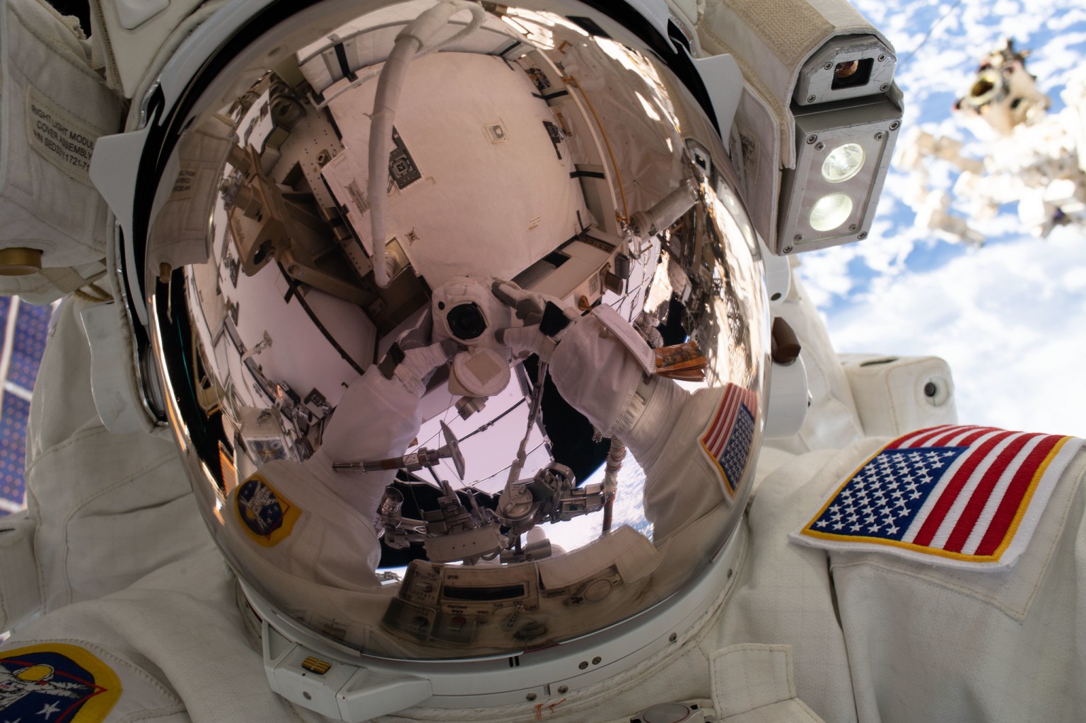 NASA astronaut Nick Hague takes an out-of-this-world "space-selfie" 250 miles above Earth during a spacewalk to upgrade the International Space Station's power storage capacity.