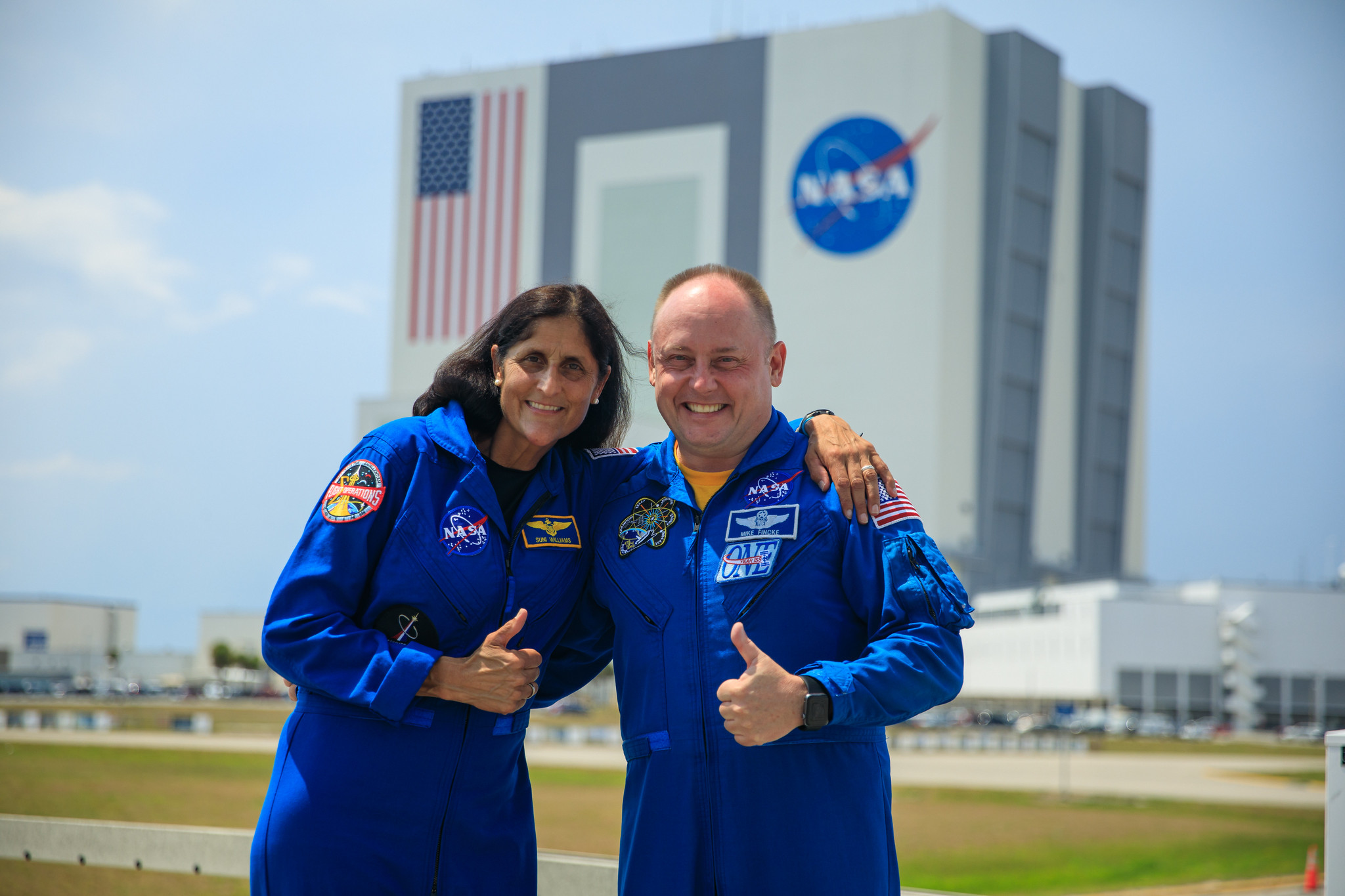 NASA astronauts Suni Williams, left, and Mike Fincke, right, pose for photographs while visiting NASA’s Kennedy Space Center in Florida, May 18, 2022, in advance of the agency’s Boeing Orbital Flight Test-2 (OFT-2) for NASA’s Commercial Crew Program. Boeing’s CST-100 Starliner spacecraft will launch atop a United Launch Alliance Atlas V rocket from Space Launch Complex-41 at Cape Canaveral Space Force Station on May 19, 2022.