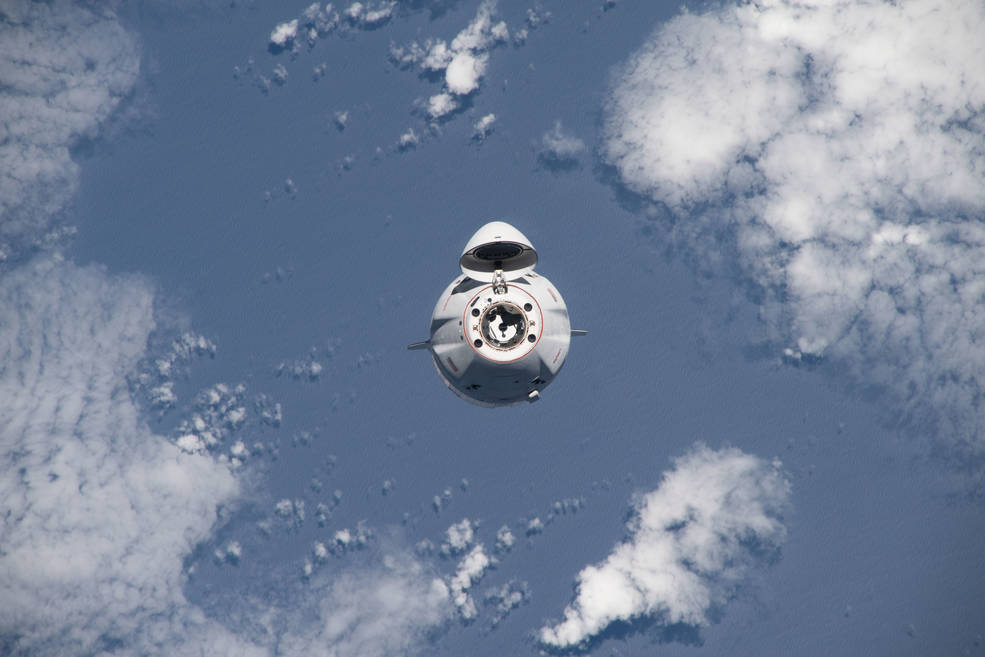 The SpaceX Dragon cargo craft, loaded with over 7,700 pounds of science, supplies, and cargo, approaches the International Space Station for a docking 264 miles above the Atlantic ocean in between South America and Africa.