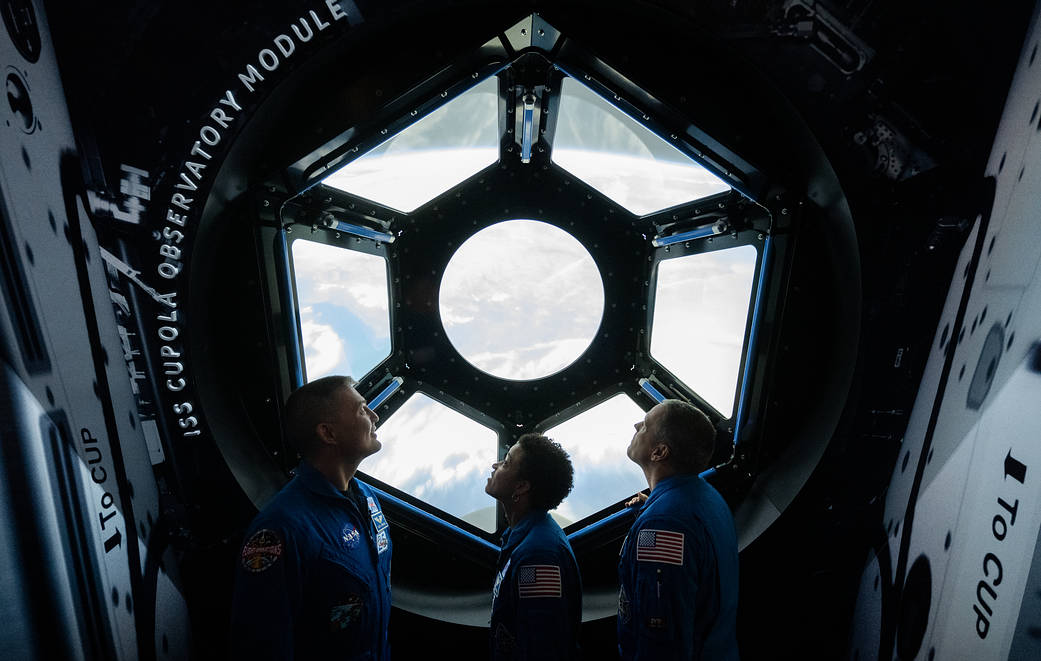 NASA astronauts Kjell Lindgren, Jessica Watkins, and Robert Hines are seen looking at an interactive recreation of the International Space Station’s Cupola March 28, 2023, at the Smithsonian’s National Air and Space Museum in Washington.