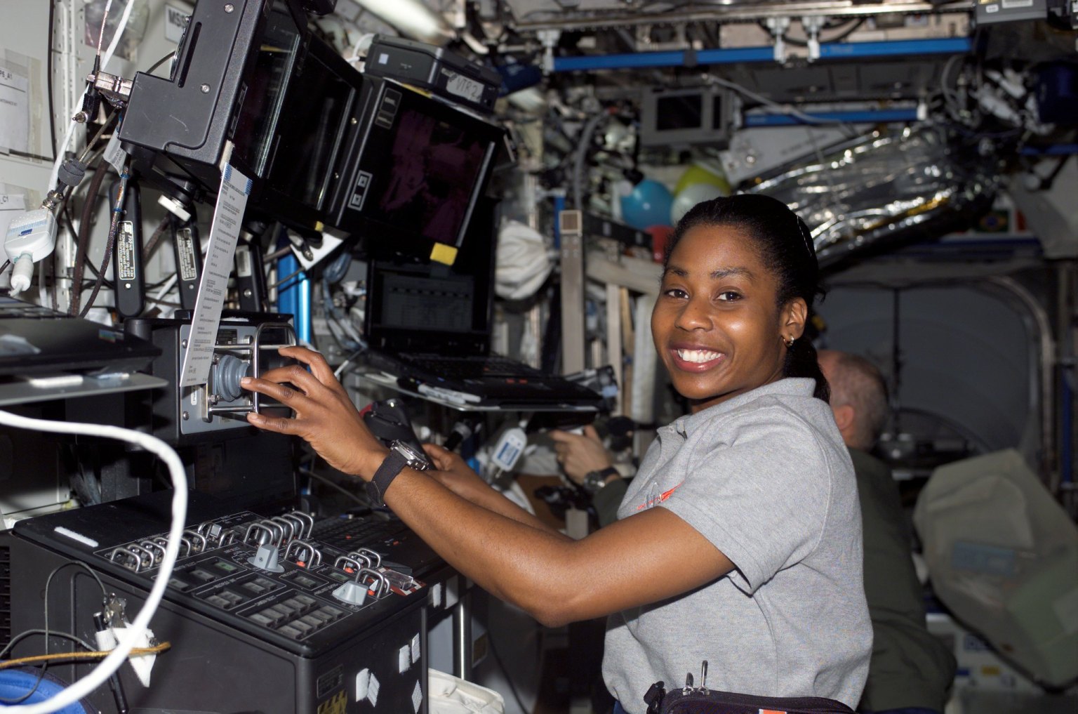 Astronaut Stephanie D. Wilson, STS-121 mission specialist, works with the Mobile Service System (MSS) and Canadarm2 controls in the Destiny laboratory of the International Space Station while Space Shuttle Discovery was docked to the station.