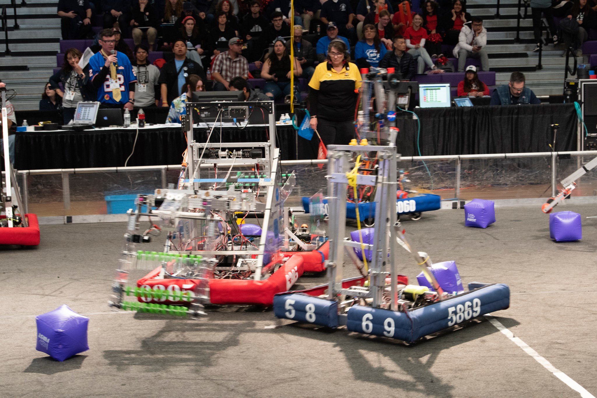 Two robots retrieve game cubes.