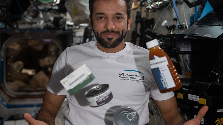 UAE (United Arab Emirates) astronaut Sultan Alneyadi seemingly juggles food canisters from the UAE in the microgravity environment of the space station.