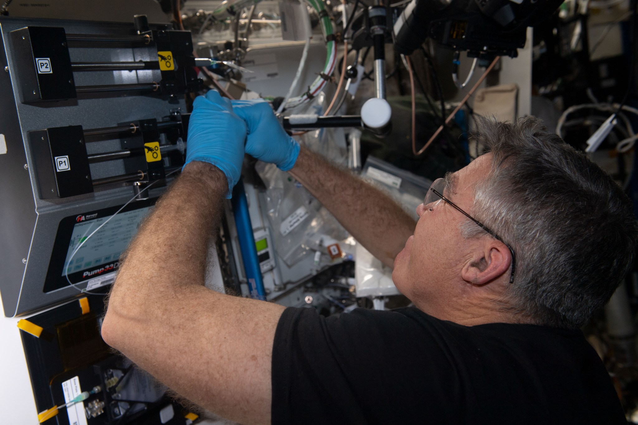 NASA astronaut Stephen Bowen conducts operations for Foams and Emulsions, an experiment that observes the dispersion of bubbles and droplets in liquids.