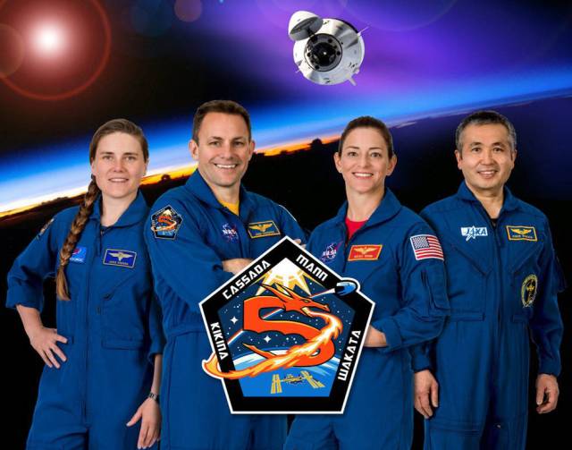 The crew of NASA’s SpaceX Crew-5 mission to the International Space Station poses for a group photo along with the official mission patch.