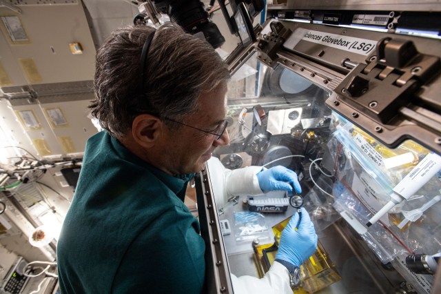 Eytan Stibbe aboard the International Space Station during the Axiom-1 (AX-1) mission in April 2022, shown here with his hands in the life sciences glovebox, or LSG, performing the Fluidic Space Optics experiment of Technion and NASA.