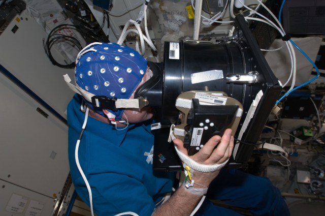 image of an astronaut using eye examination equipment
