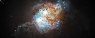 This artist's concept shows the brilliant glare of two quasars residing in the cores of two galaxies that are in the chaotic process of merging. 