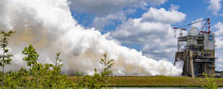 Steam and smoke fill the left side of the photo during a RS-25 hot fire test on the Fred Haise Test Stand at NASA’s Stennis Space Center in south Mississippi on April 26, 2023.
