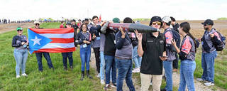 Students from the University of Puerto Rico-Mayaguez, carry their rocket to the launch pad during NASA’s 2023 Student Launch.